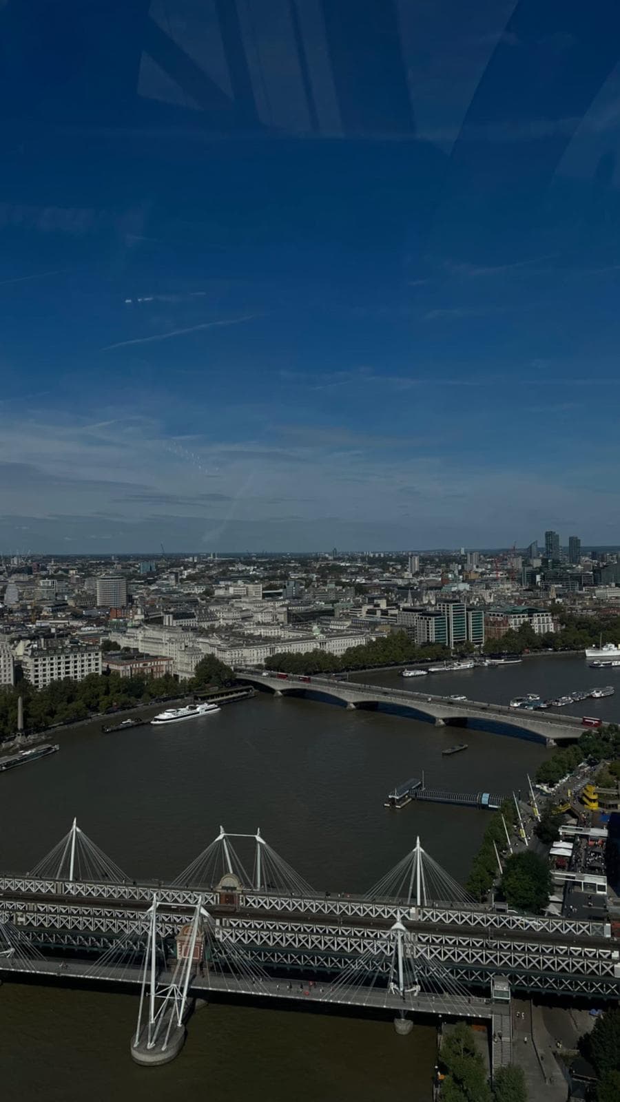 The Thames from above, looking across Hungerford Bridge and Waterloo Bridge toward the city.